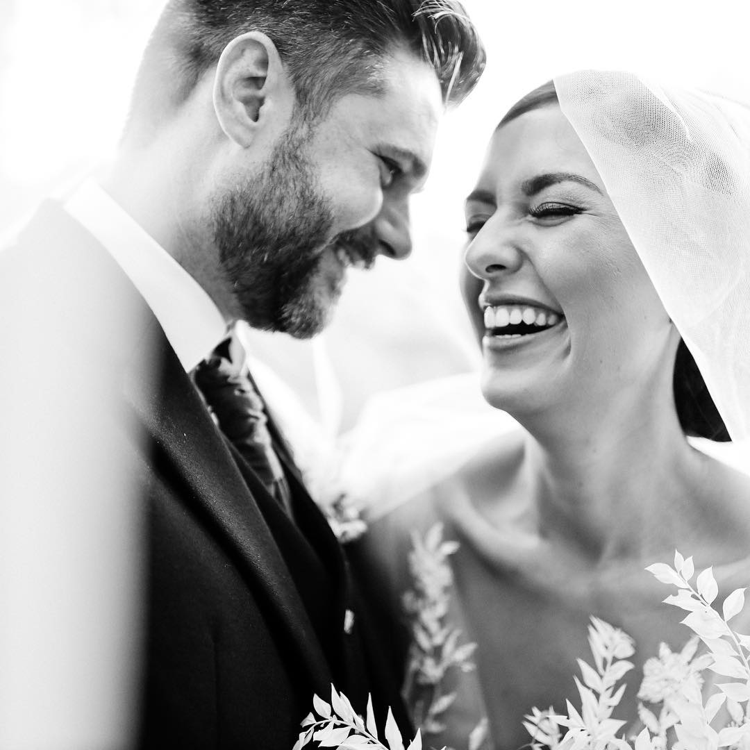 Black and white portrait of a bride and groom smiling
