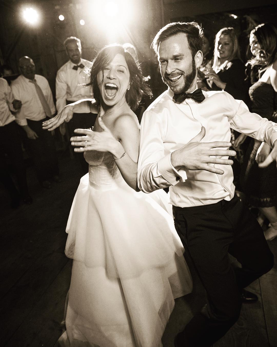 Black and white portrait of a bride and groom dancing 