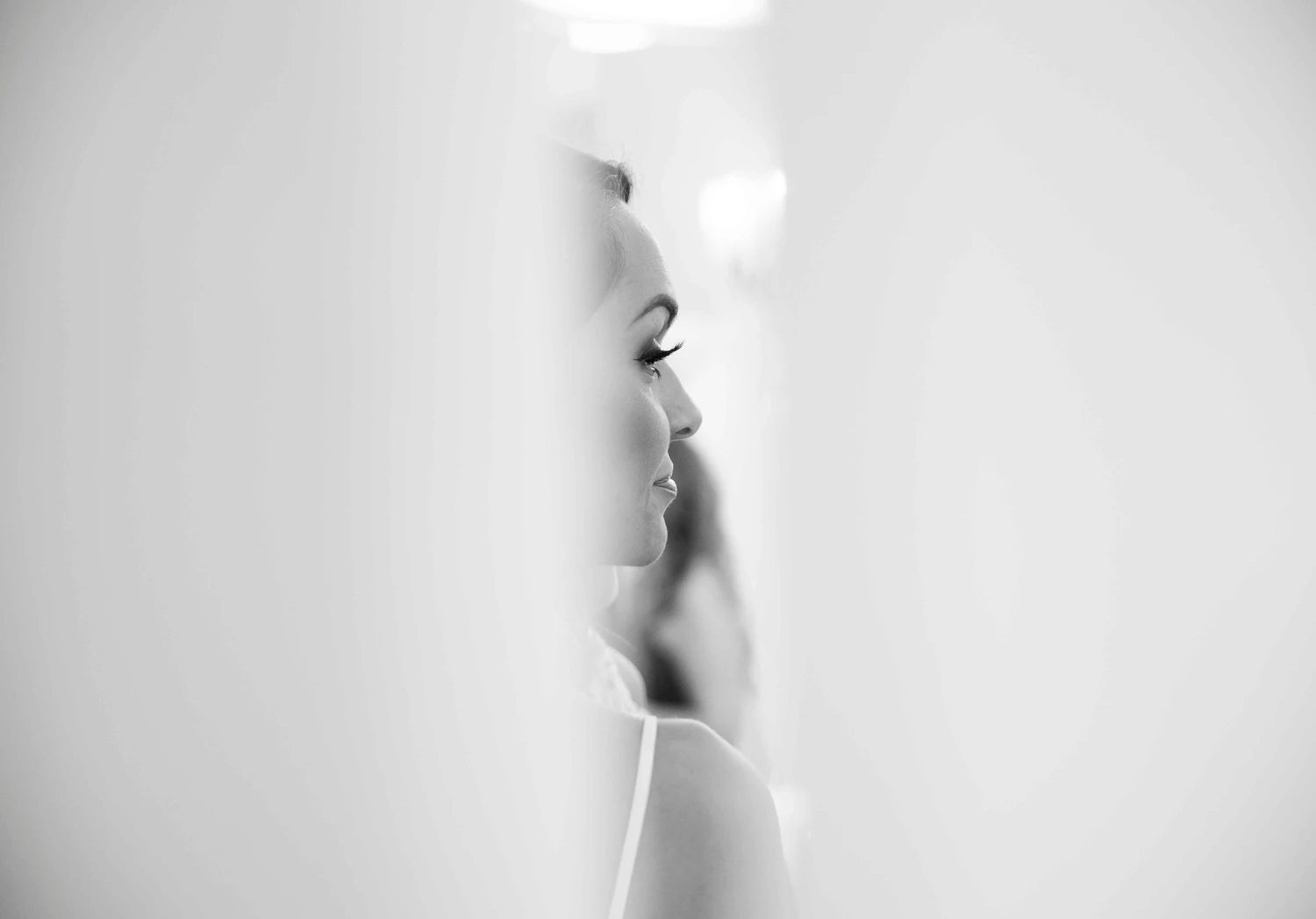 A black and white portrait of a bride