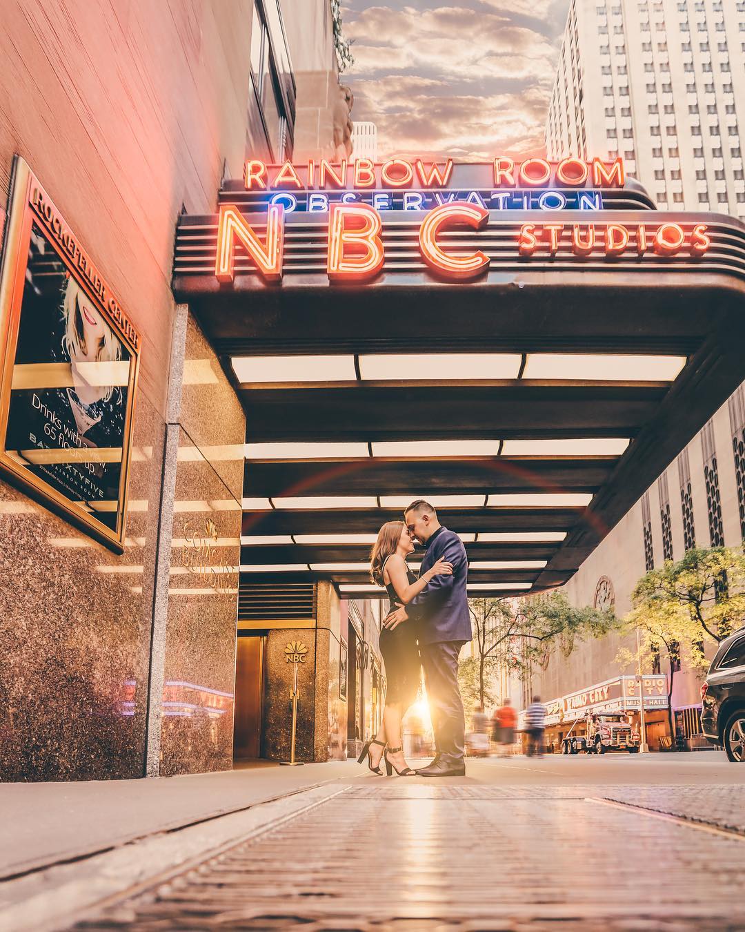 A couple posing on a street side in front of NBC Studios on an engagement session 