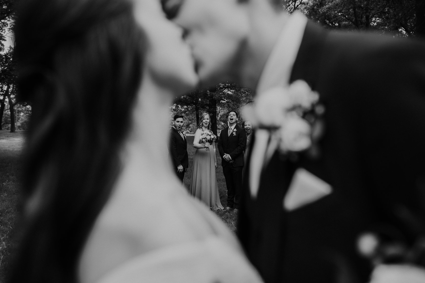 A monochrome close up shot of a couple kissing
