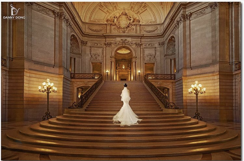 A bride walking up the stairs (a scene from a high-end weddings)