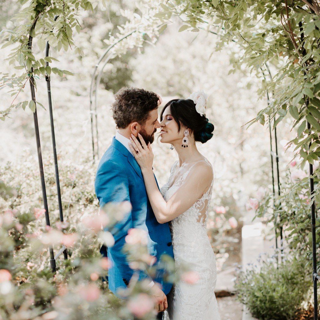 A wedding portrait of a bride and groom in a garden